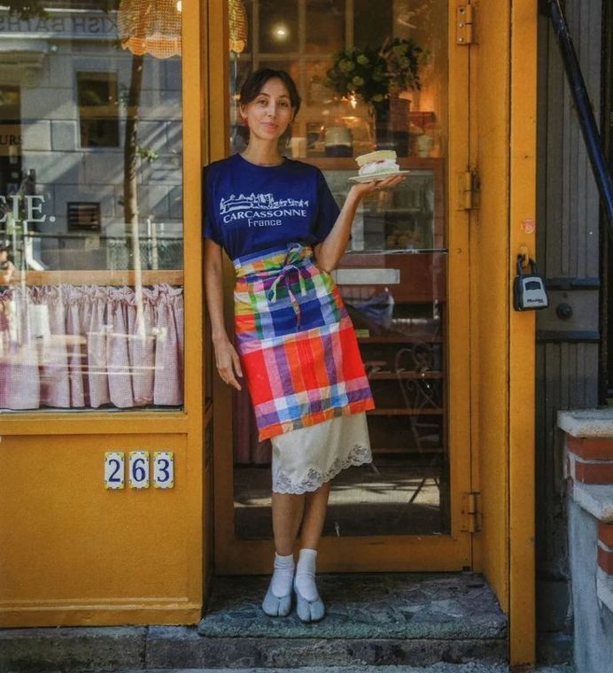 A café owner in their doorway