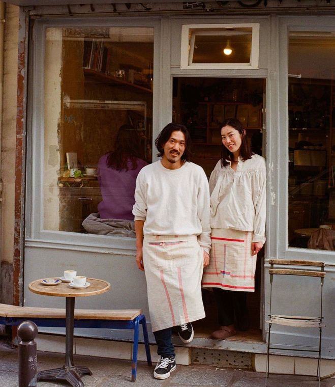 Two café owners outside their shop